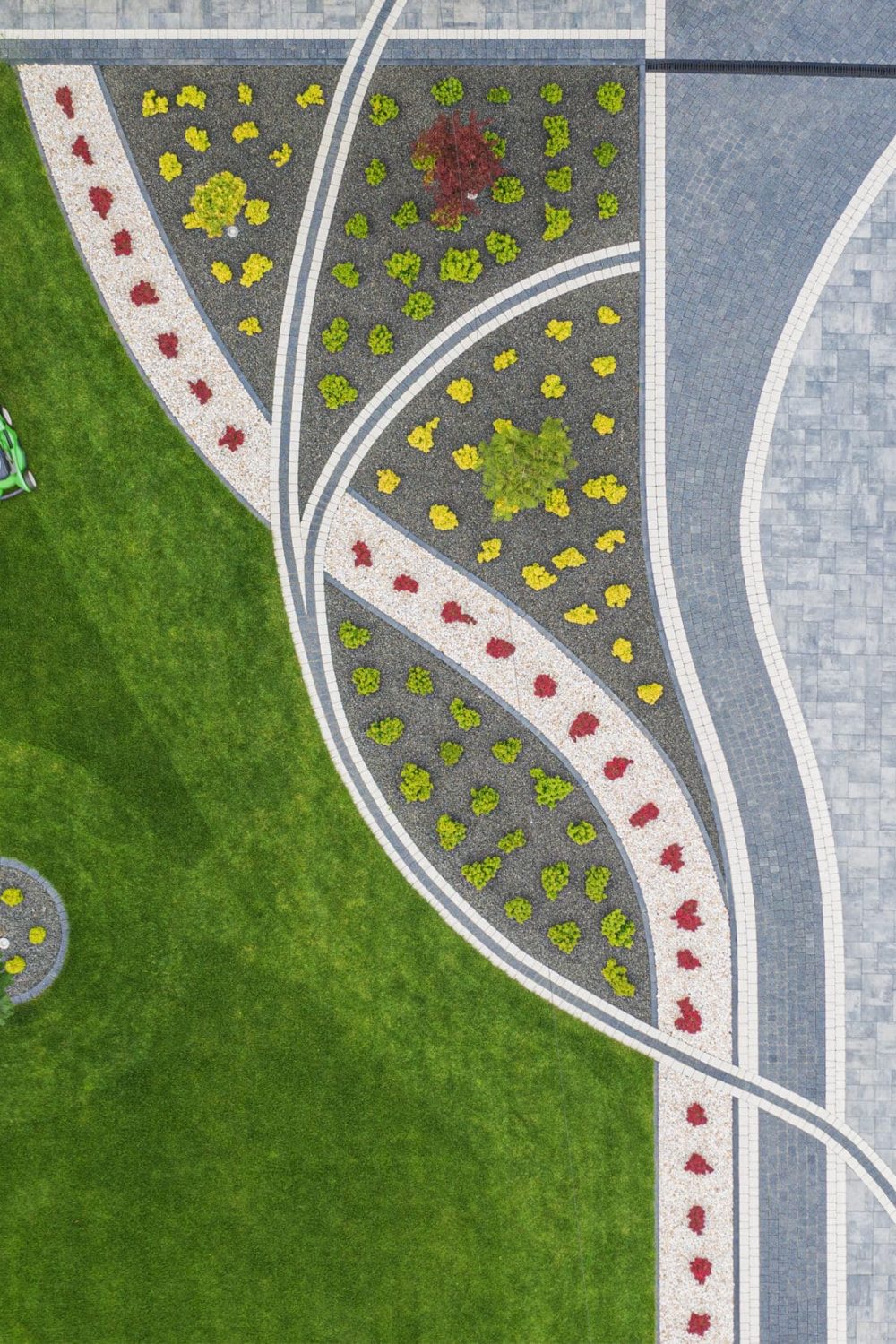 Grass Mowing by Caucasian Men and Taking Care of Front Yard Garden. Modern SUV Sport Utility Vehicle on a Driveway. Aerial View.