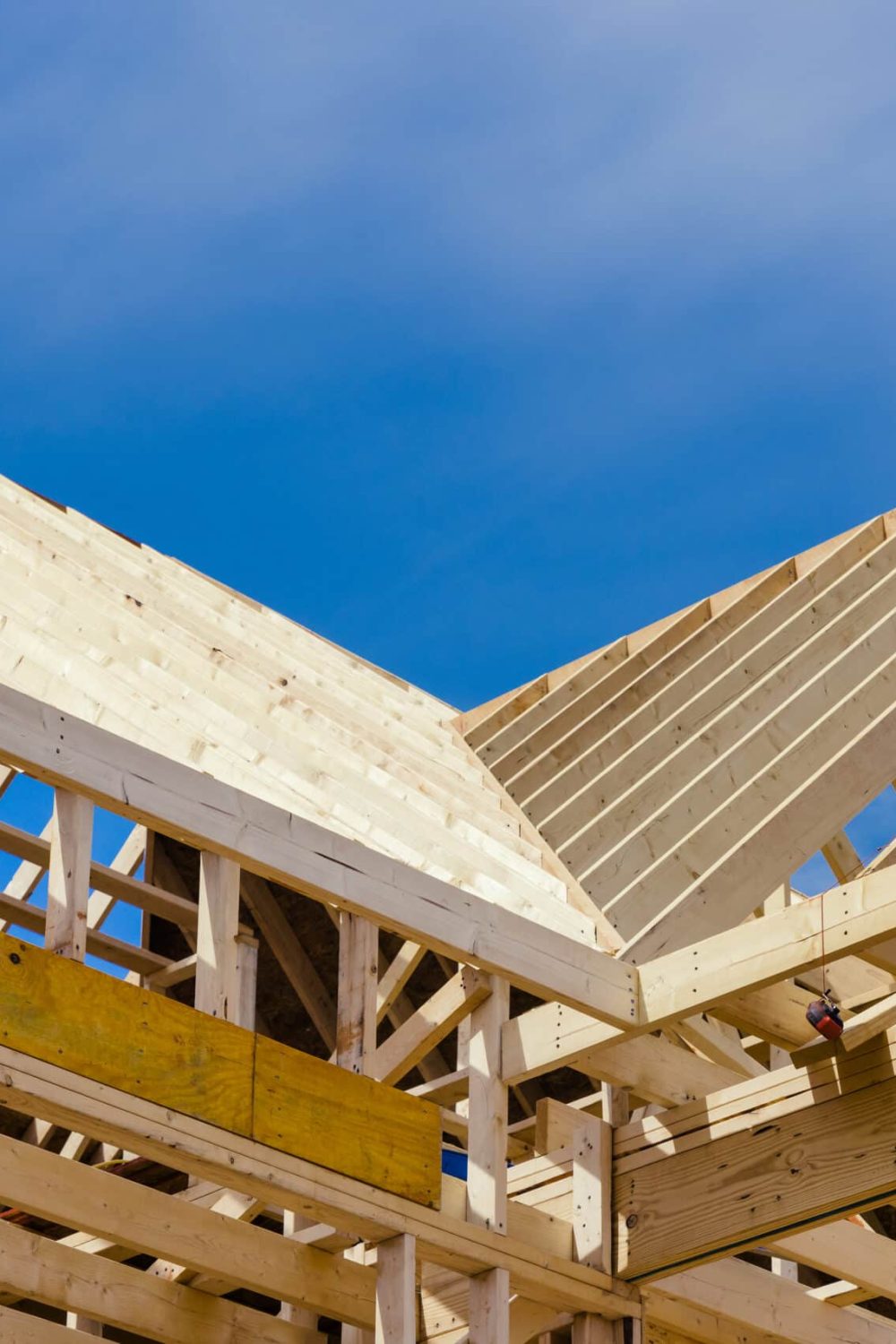A new residential construction home framing with a roof view