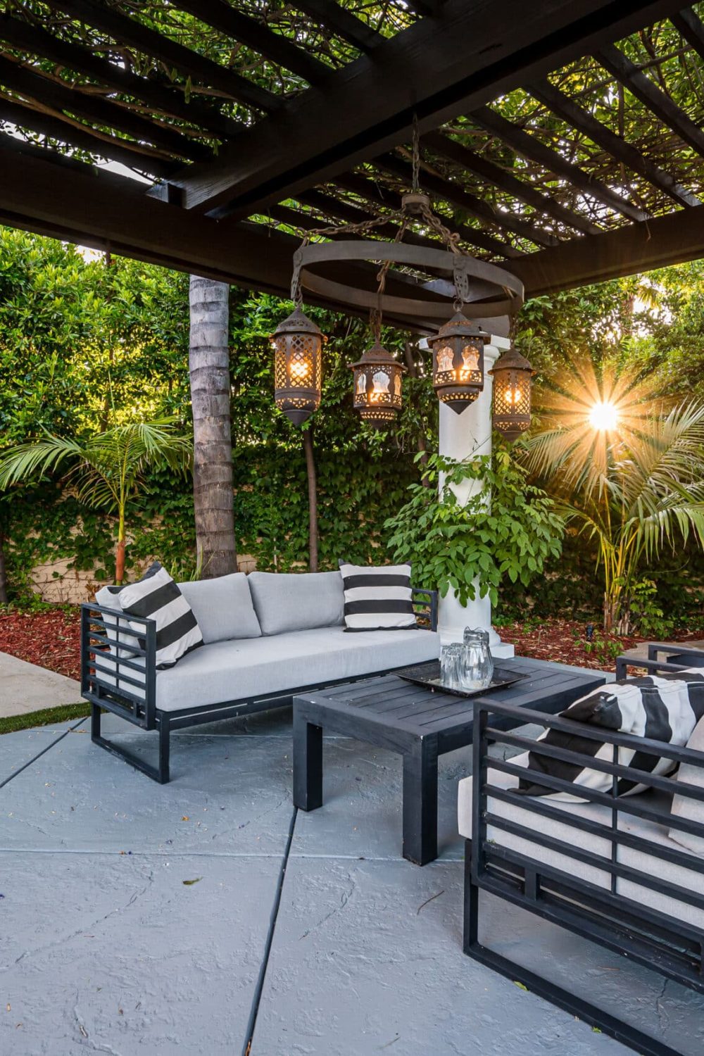 A patio with white couches and chairs in a modern new construction home in Los Angeles
